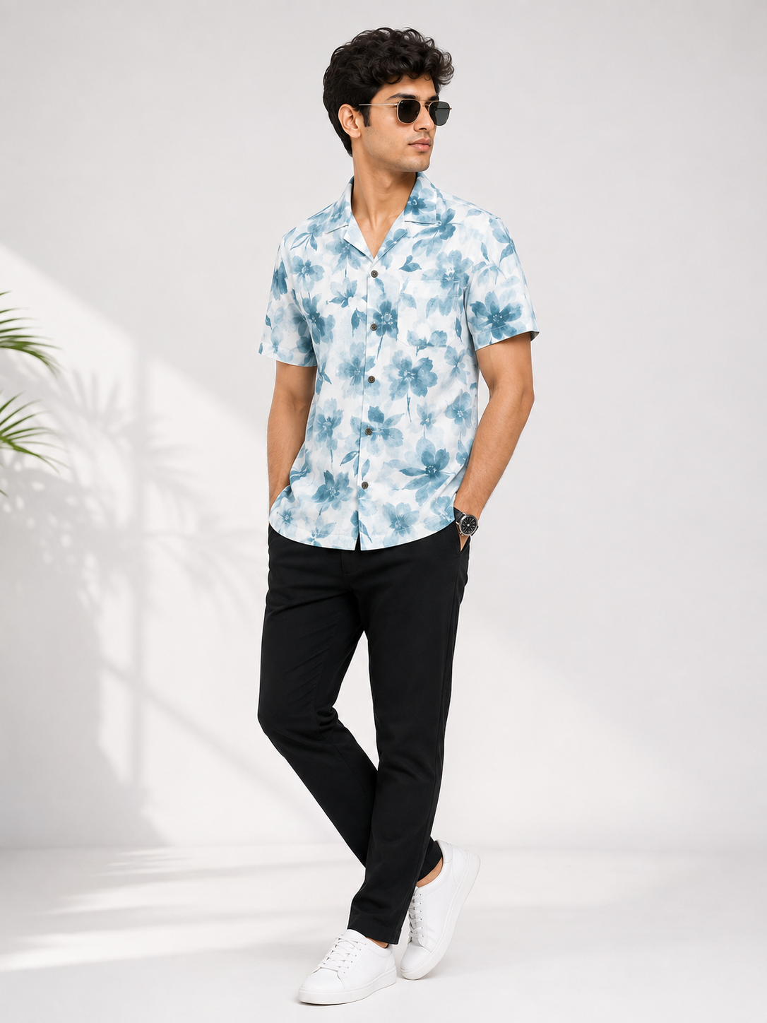 Blue floral shirt styled with black trousers and white sneakers